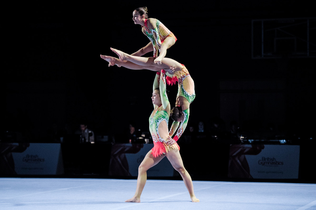 Trio of acrobatic gymnasts performing amazing balance